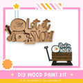 a DIY wood paint kit for creating winter-themed decorations, including a wooden snowman and a wooden wagon.