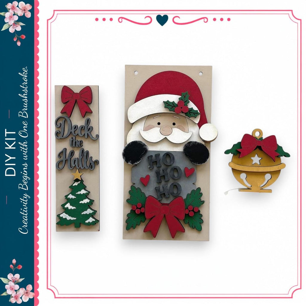 a DIY kit for creating Christmas decorations, including a wooden Santa Claus figure, a Christmas tree, and a bell ornament.