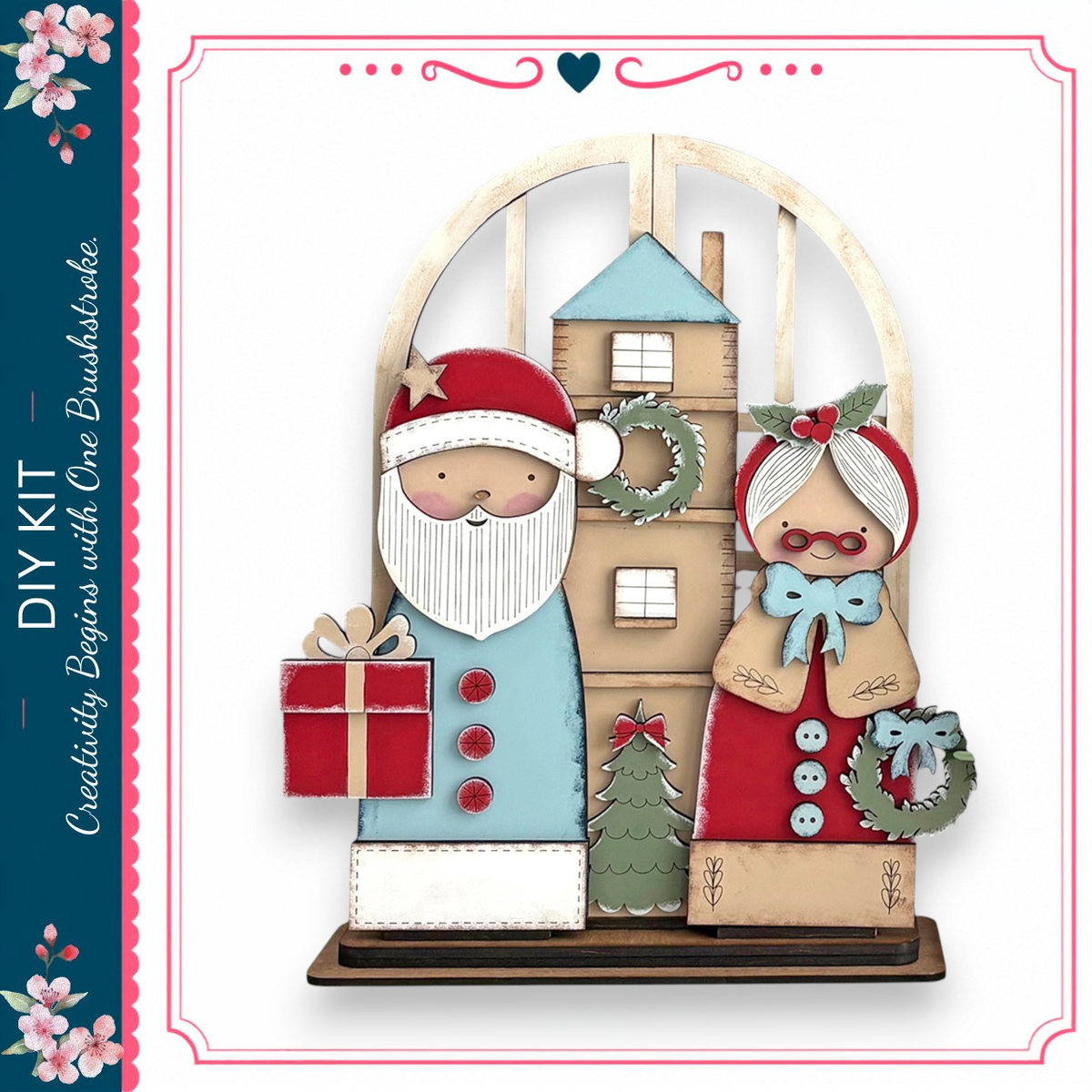 A wooden Christmas tree with a Santa Claus figure holding a gift and a wreath-adorned woman holding a Christmas tree.