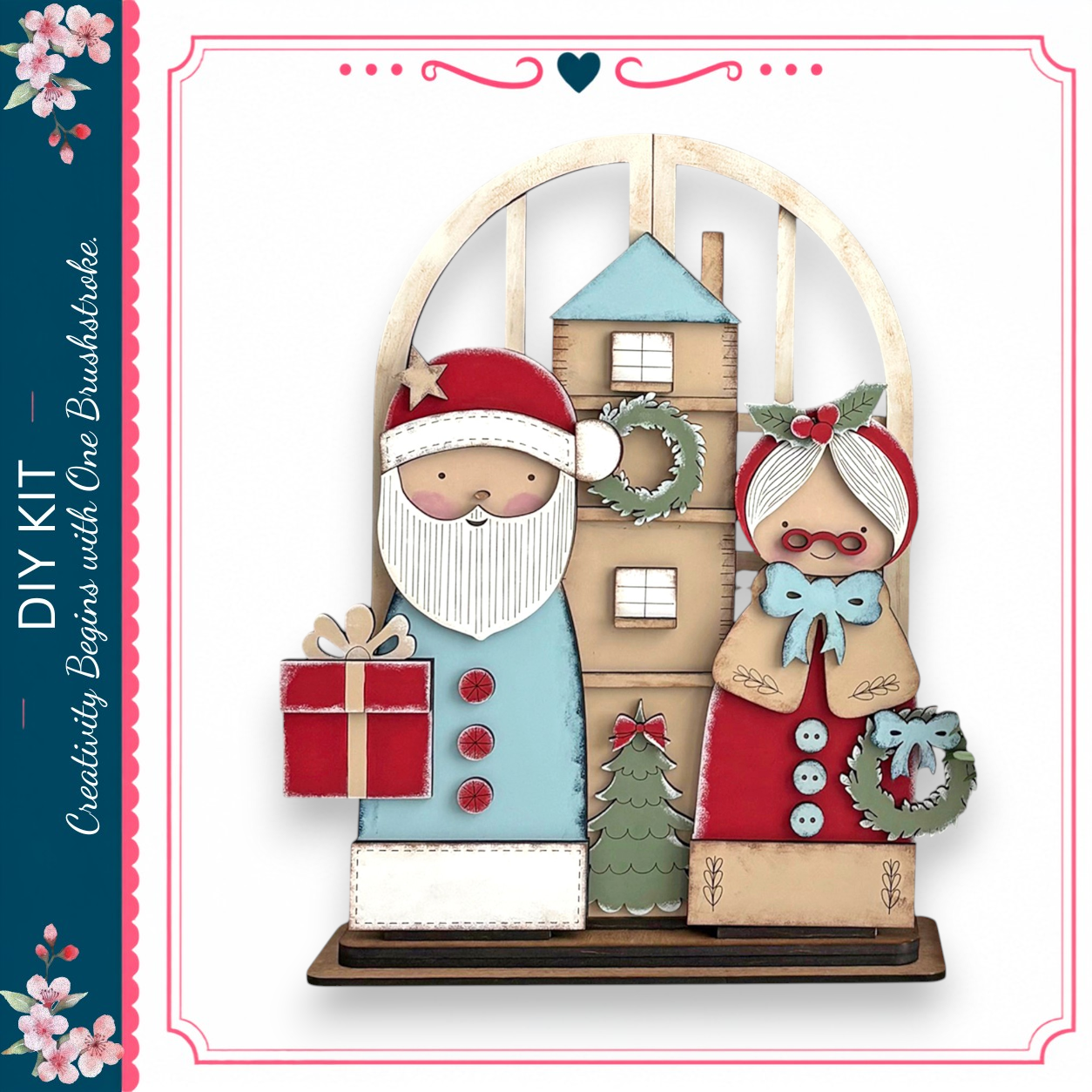 A wooden Christmas tree with a Santa Claus figure holding a gift and a wreath-adorned woman holding a Christmas tree.