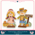 two scarecrow figures, one male and one female, standing next to each other with a sign that says "Scarecrow on Duty".