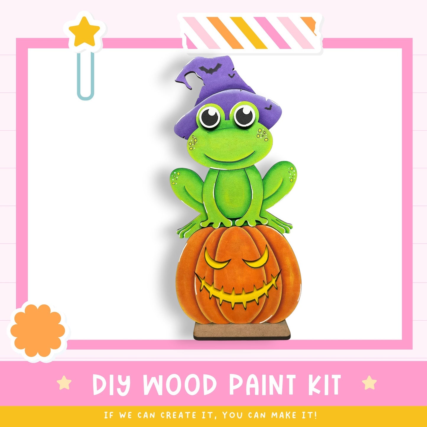 A wooden frog wearing a witch's hat sits atop a carved pumpkin, with a star decoration above the frog.