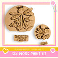 a DIY wood paint kit, including a dragonfly-shaped cutout and a spring-themed cutout, both made of wood. The kit is designed for creating custom wooden designs, such as the dragonfly and spring motifs.