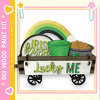a wooden wagon with a pot of gold coins on top, along with a sign that says "Lucky Me".