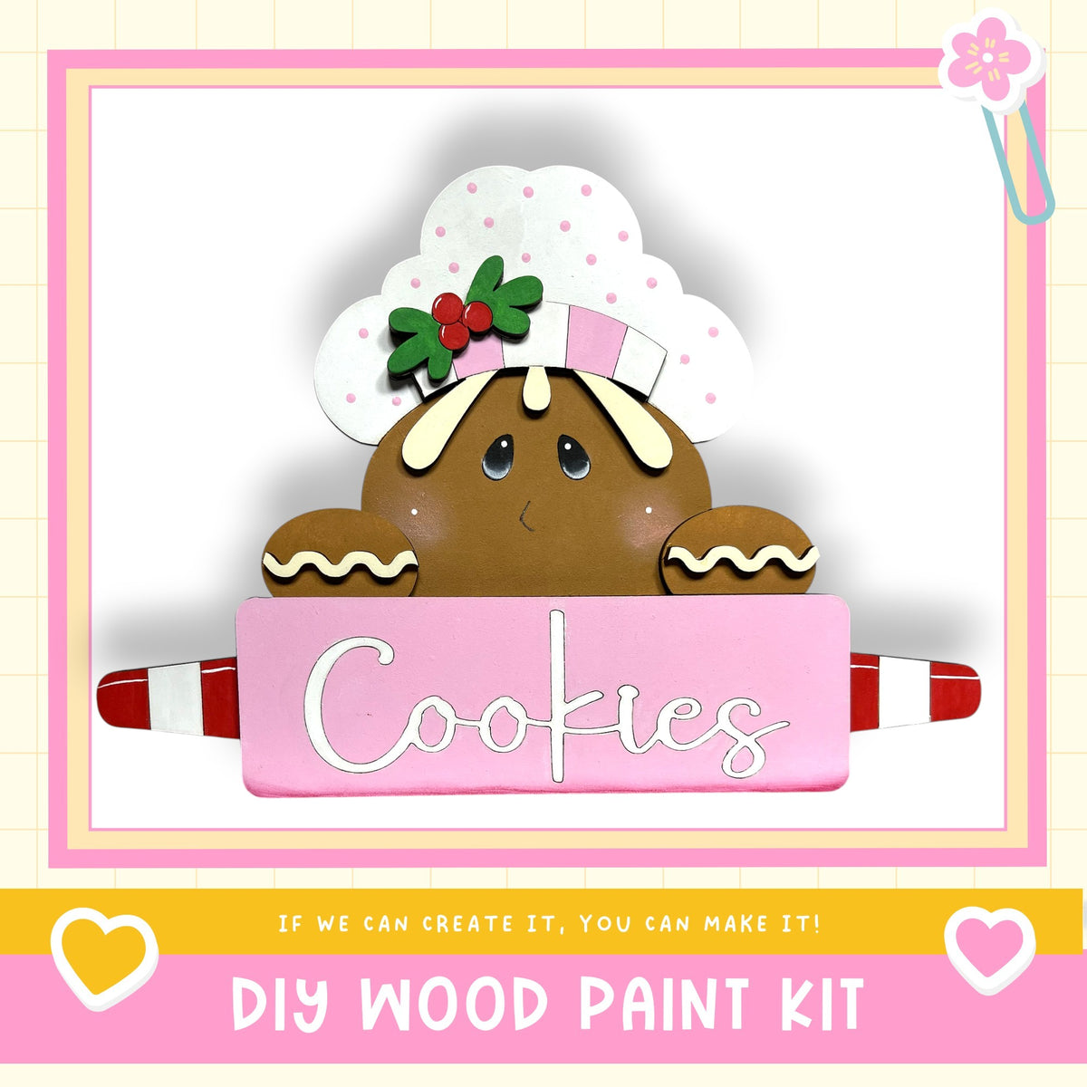 A wooden gingerbread man figure holding a sign that says "Cookies" in a pink background.