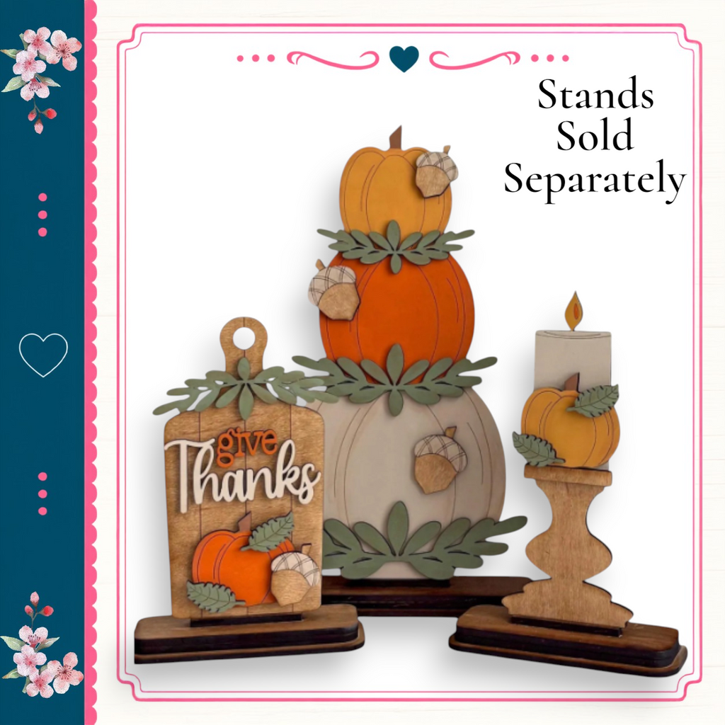 a set of wooden ornaments, including a carved pumpkin, a candle holder, and a wooden sign with the phrase "give thanks". The ornaments are arranged in a festive manner, suggesting they are intended for use during the Thanksgiving holiday season.