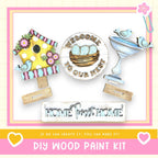 The image is a DIY wood paint kit featuring a birdhouse, a sign that says "Welcome to our nest", and a sign that says "Home sweet home". The kit appears to be made of wood and is designed to be used as a decoration or home improvement project.