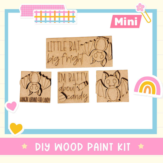 The image is a DIY wood paint kit featuring a variety of bat-themed designs, including a bat silhouette and a bat with a "I'm batty about candy" message. The kit appears to be a creative and fun project for children to engage in.