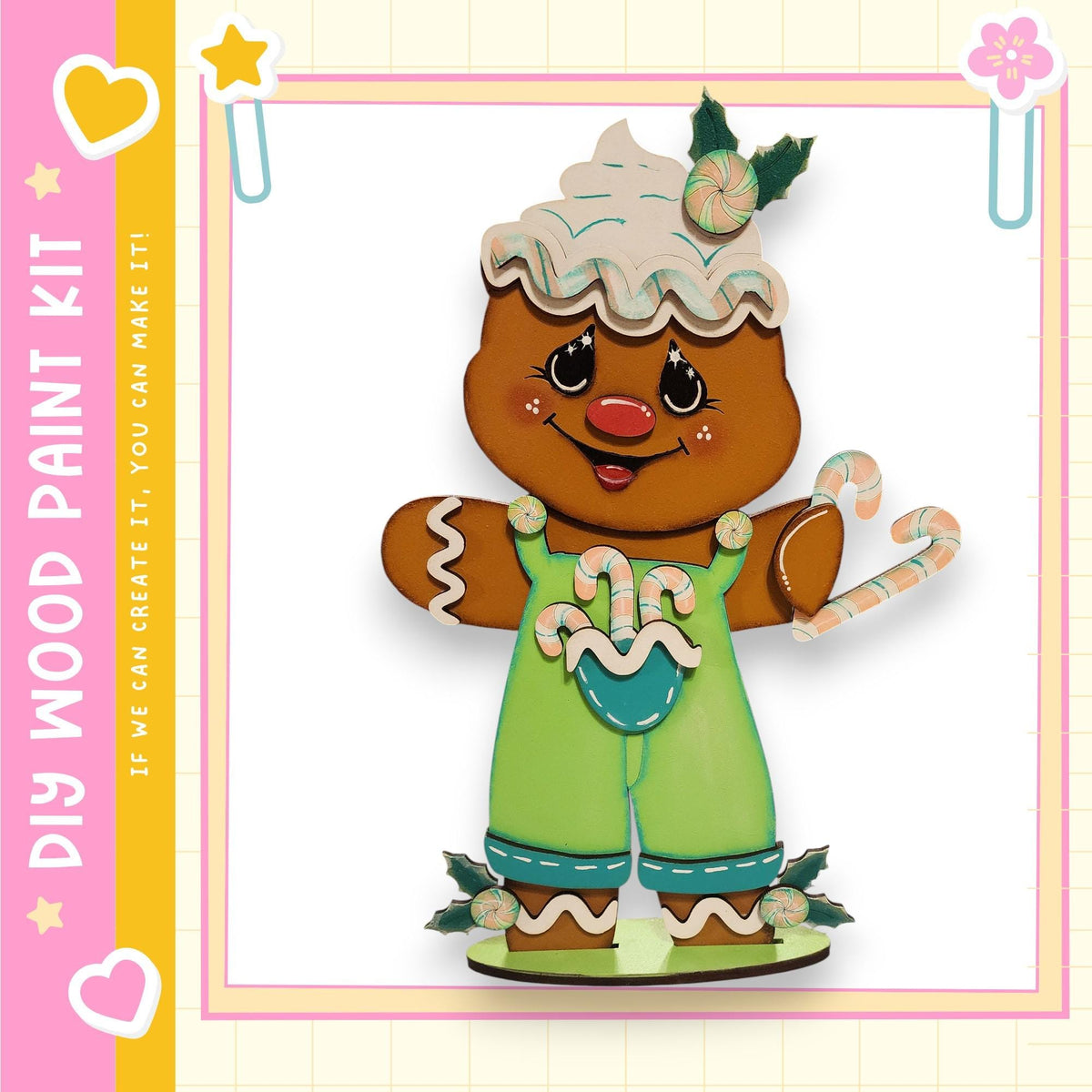 A wooden paint kit depicting a gingerbread man with a white hat and green overalls, holding a candy cane.