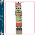 A vertical wooden sign with various decorative elements, including a horseshoe, a welcome sign, and a leprechaun. The sign appears to be a creative DIY project, possibly for a holiday celebration.