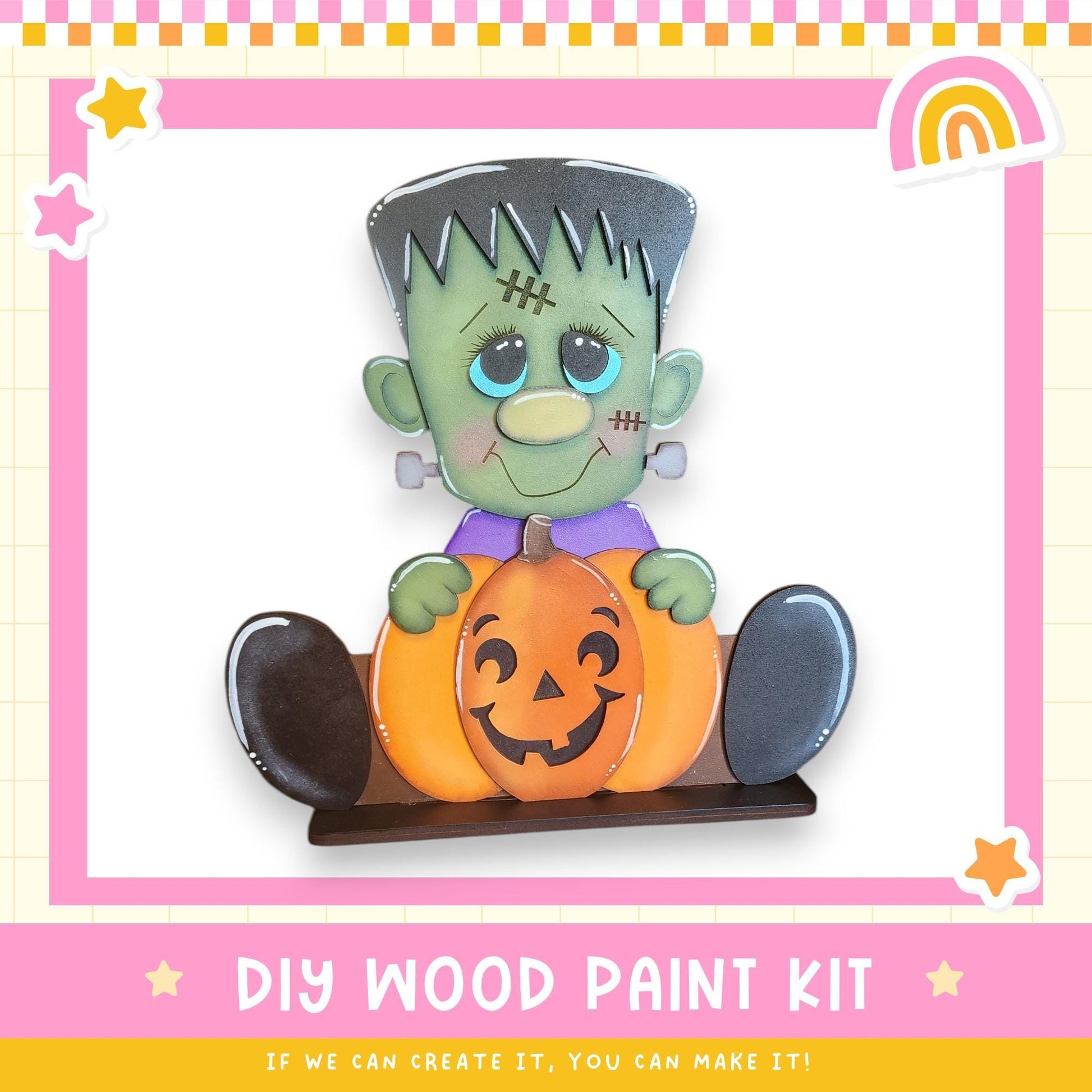 A DIY wood paint kit featuring a carved pumpkin and a carved green monster character, with a pink and yellow border and stars around the edges.