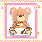 a brown teddy bear sitting on top of a bowl