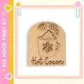 A wooden paint kit with a snowflake design and the word "Hot Cocoa" written on it.