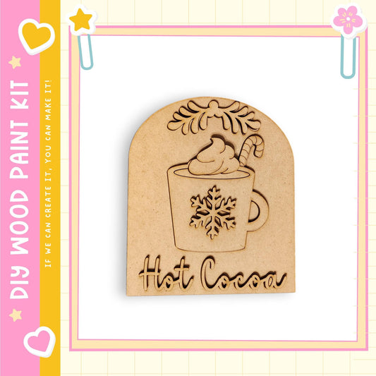 A wooden paint kit with a snowflake design and the word "Hot Cocoa" written on it.