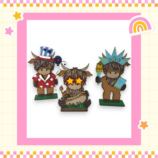 three cartoon cow figurines wearing hats and holding various objects, such as a book and a toy gun.