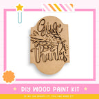 a wooden stamp that says give thanks on it