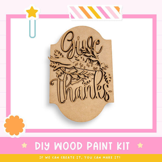 a wooden stamp that says give thanks on it
