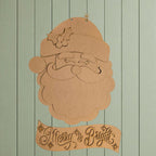 A cardboard cutout of Santa Claus with a holly leaf on his hat, and a banner with the text "Merry & Bright" below it.