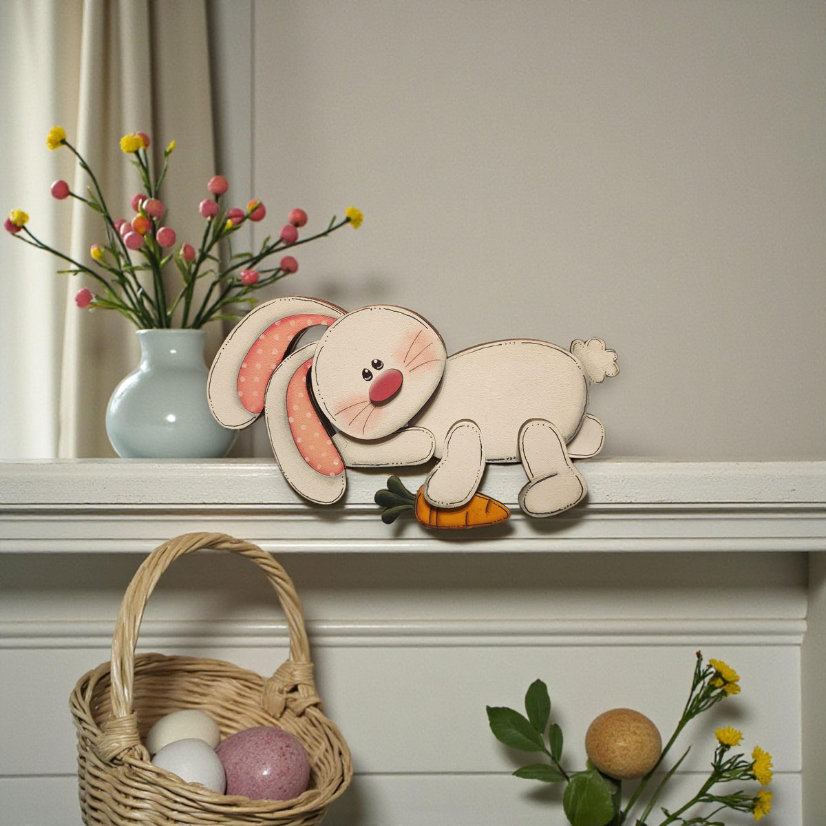 a shelf with a decorative Easter bunny figure, a vase of flowers, a woven basket, and some Easter eggs.
