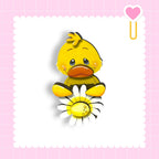 A cheerful yellow duck holding a flower is the central focus of the image, set against a pink background with a scalloped edge.