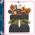 a pair of green monster boots with Halloween-themed decorations, including a jack-o-lantern, a ghost, and candy corn.