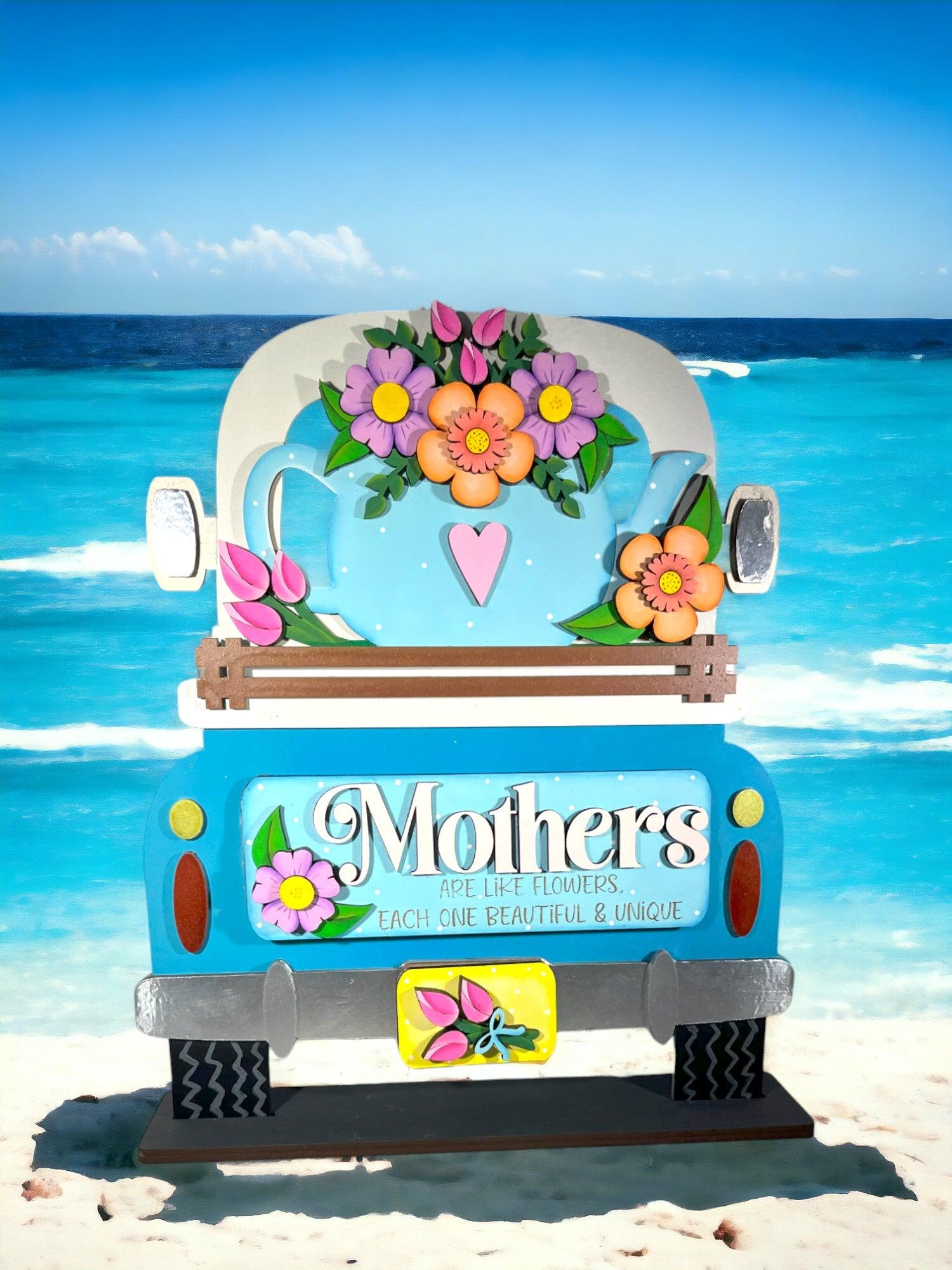 a blue truck parked on top of a sandy beach