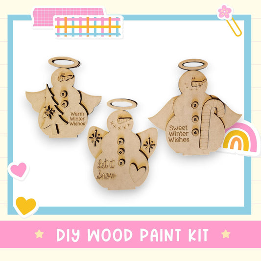 three wooden ornaments, each with a unique design and text, displayed against a white background. The text on the ornaments includes phrases like "Warm Winter Wishes" and "Let it snow". The image also includes a "DIY WOOD PAINT KIT" label at the bottom.