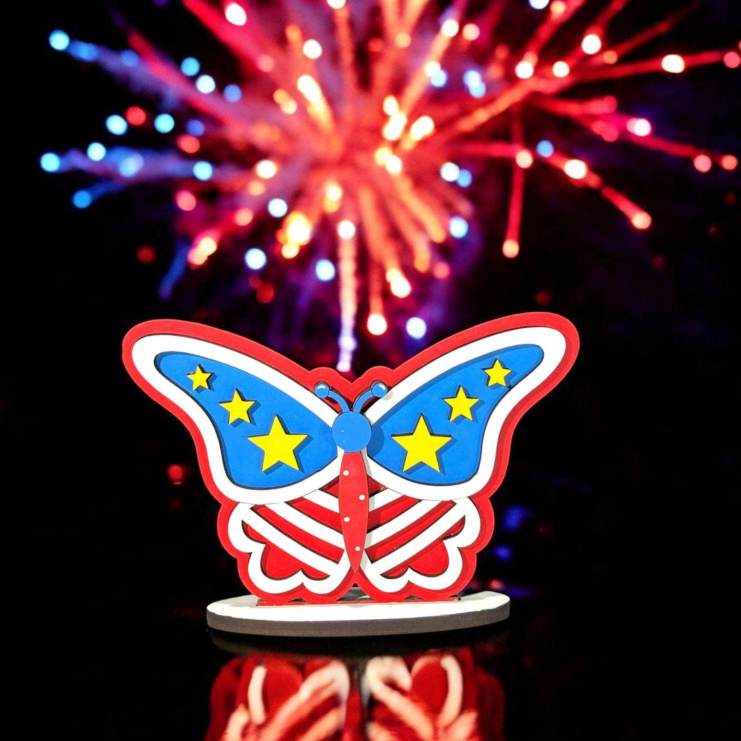 a red, white and blue butterfly with fireworks in the background