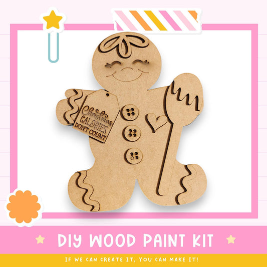 a DIY wood paint kit for creating a wooden gingerbread man. The kit includes a wooden gingerbread man figure and a label that says "Christmas Calories Don't Count".