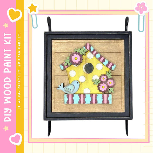 a wooden birdhouse with a bird perched on it, set against a wooden background with colorful flowers.
