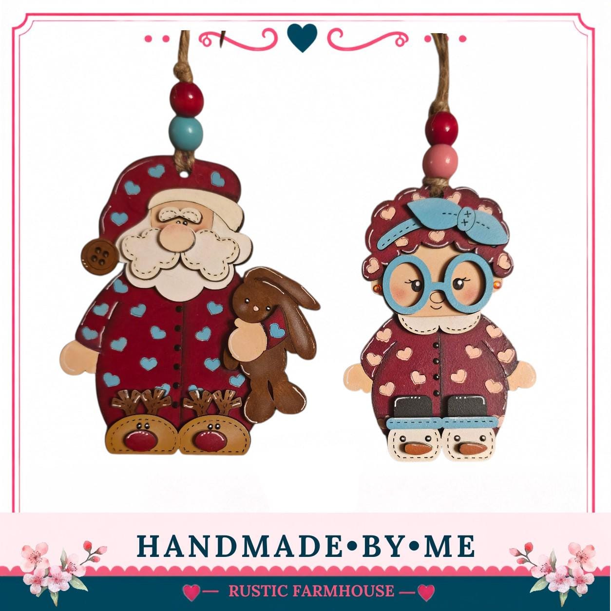 two wooden ornaments, one depicting Santa Claus and the other a little girl, hanging from a string.