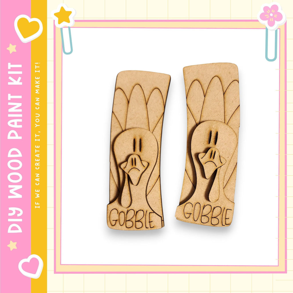 two wooden turkey-shaped cutouts with the word "GOBBLE" written on them.