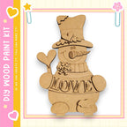 A wooden snowman kit with the word "LOVE" written on it, along with a heart and star decoration.