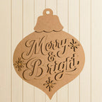 A wooden ornament with the text "Merry & Bright" carved into it.
