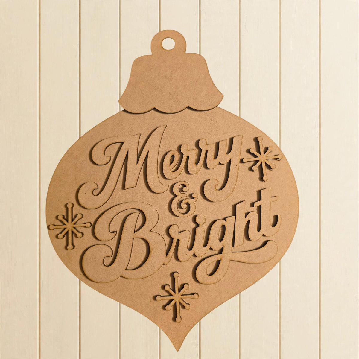 A wooden ornament with the text "Merry & Bright" carved into it.