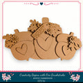 A wooden pumpkin decoration with hearts and leaves, featuring the word "Harvest" on it. The pumpkin is part of a larger wooden decoration set, and the image is described as a DIY kit from a rustic farmhouse.