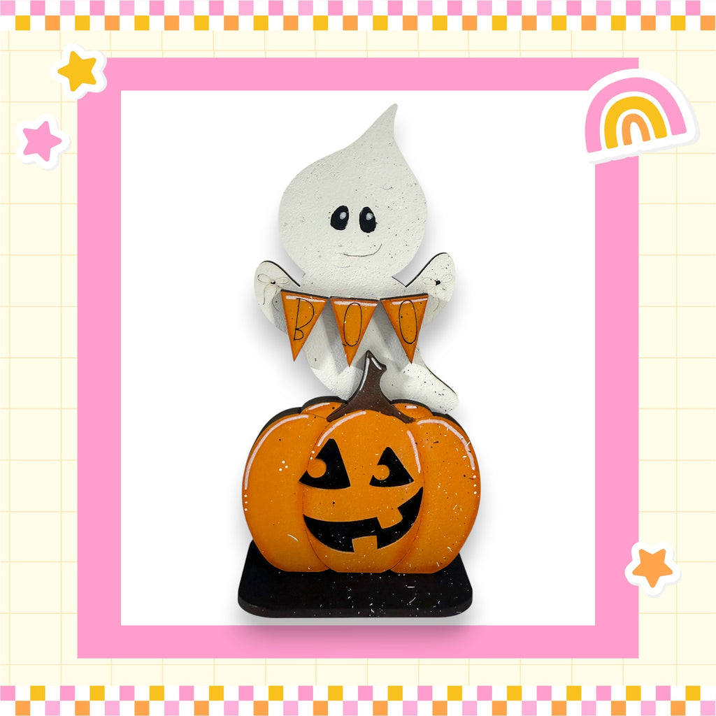 A Halloween-themed decoration featuring a ghost and a carved pumpkin.