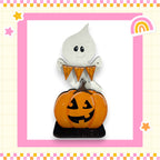 A Halloween-themed decoration featuring a ghost and a carved pumpkin.