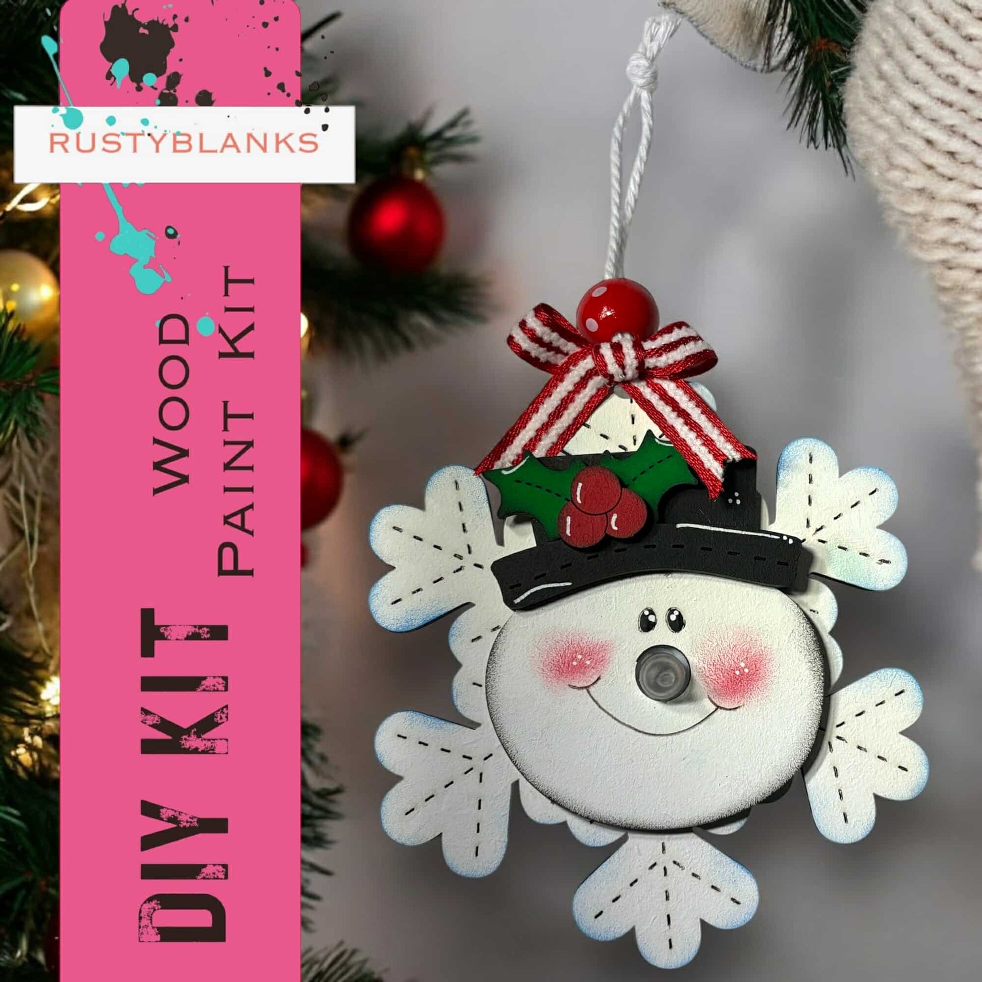 a snowman ornament hanging from a christmas tree