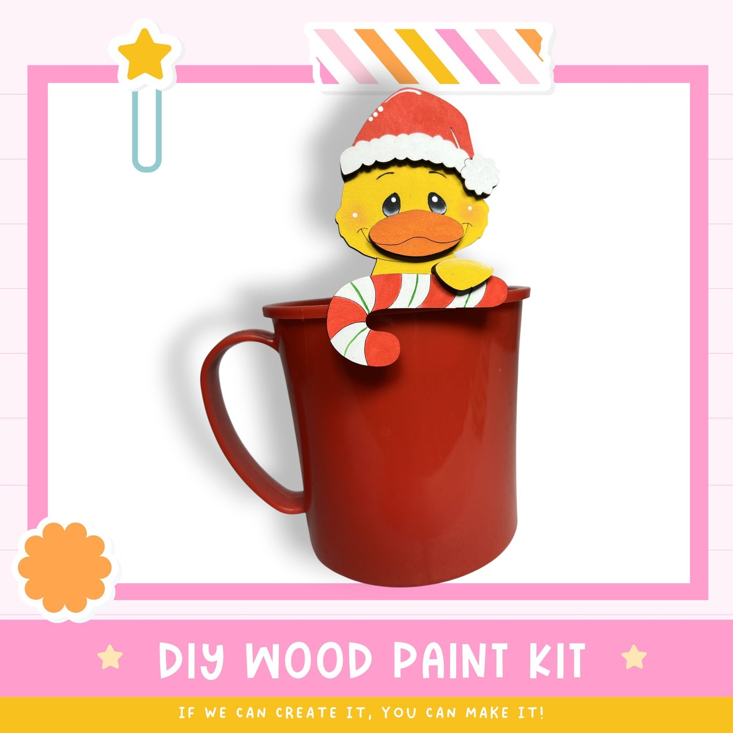 A red mug with a yellow duck wearing a Santa hat, sitting inside it, and surrounded by a pink and white striped border.
