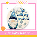 a DIY wood paint kit for creating a wooden sign with a gnome design. The kit includes a gnome illustration and the text "chillin' with my gnomes" written on the sign.