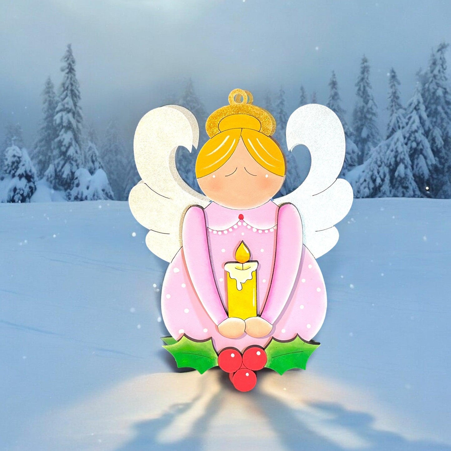 a paper cut angel sitting in the snow holding a candle