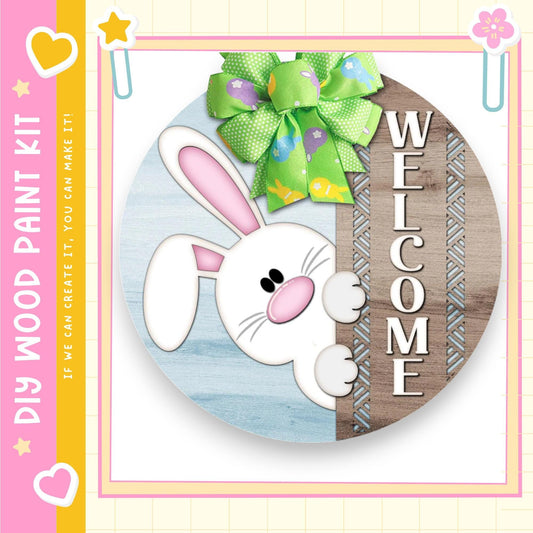 a round wooden sign with a cartoon rabbit and a green bow, along with the word "WELCOME" written on it.