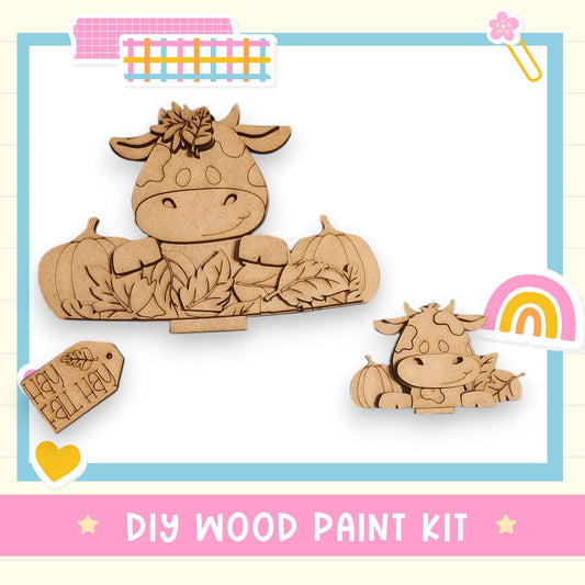 a DIY wood paint kit, including a wooden cow and pumpkin decoration, along with a tag and a rainbow.