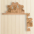 A wooden shelf with various cardboard cutout mice and presents on it.