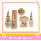 a DIY wood paint kit with various wooden shapes and decorations, including a snowman, a tree, and a snowflake.