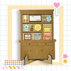 A wooden cabinet with various decorative items and a sign that reads "The Family" is displayed in the image.