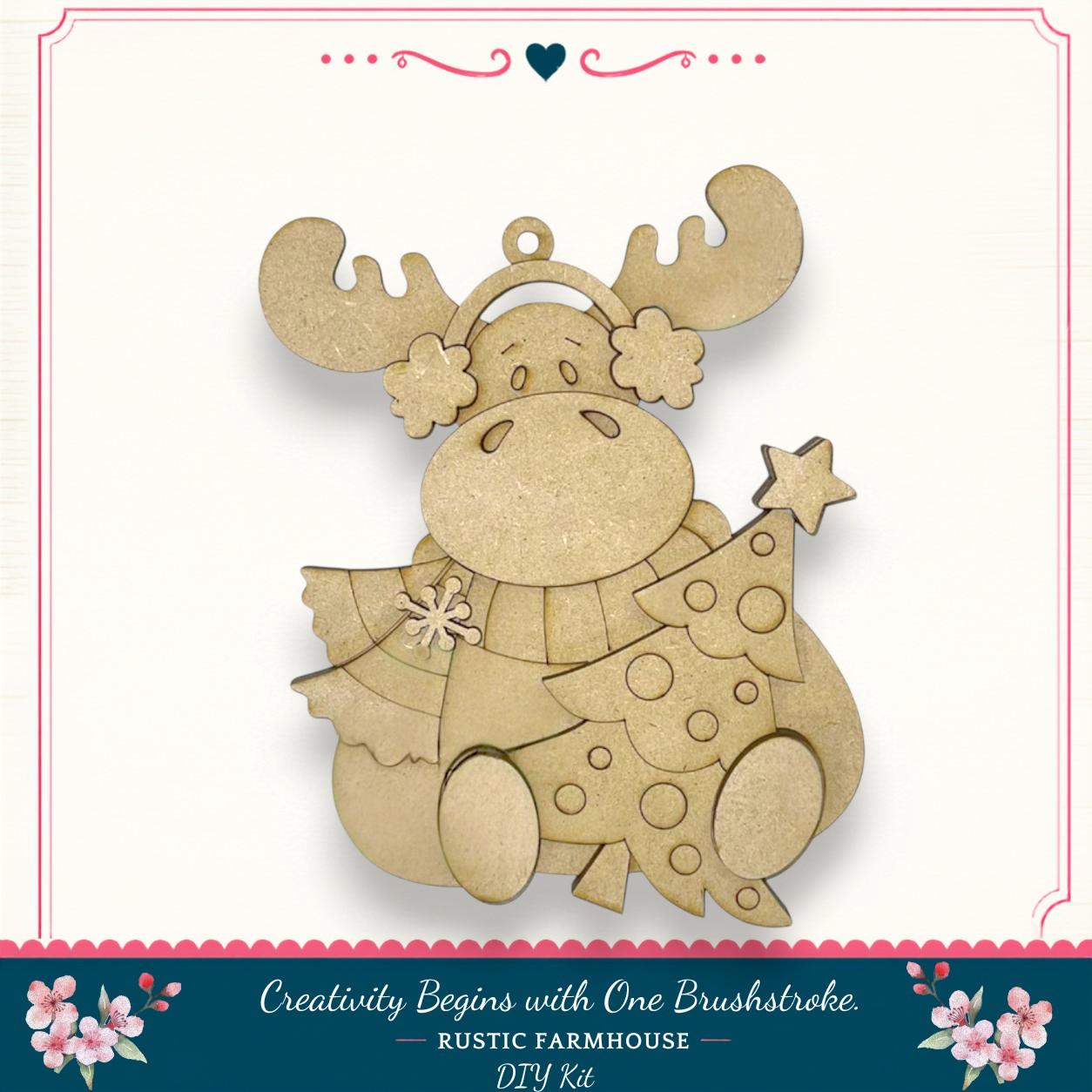 A wooden ornament in the shape of a moose, with antlers and a star, is displayed against a white background.
