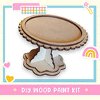 a DIY wood paint kit, with a wooden cake stand and a heart-shaped decoration.
