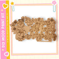 A wooden cutout of an angel with wings and a halo, along with the text "Hark! the herald angels sing" carved into it.